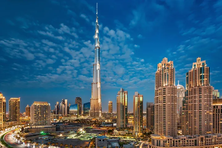 Burj Khalifa rising above the Dubai skyline under a blue sky